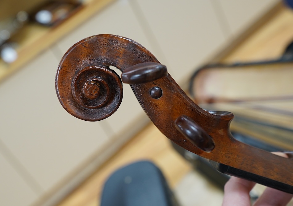 An early 20th century cased Welsh violin, the handwritten label inside the body reads; ‘James Parkinson, Llandudno No.9, 1921’, with a single piece back, inlaid stringing to the edge of the body, length of body 35.5cm, t